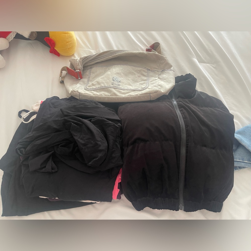 Bundle of clothes and Kipling bag
